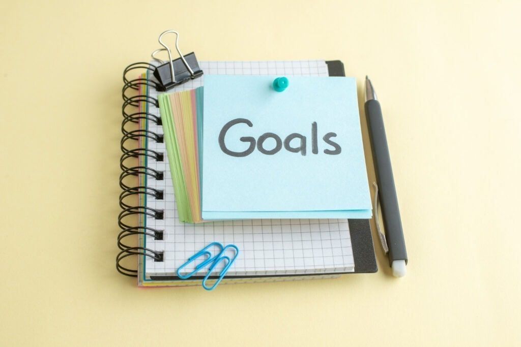 front view goals written note along with colorful little paper notes light background 1