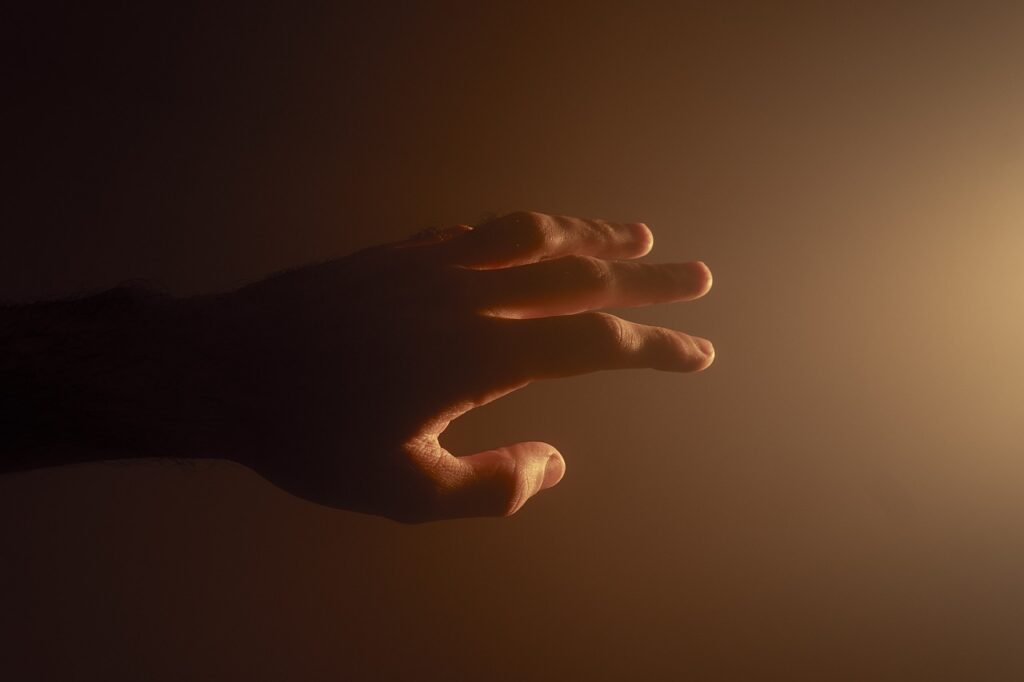 A hand reaching out to another with an Hello, symbolizing a gesture of kindness and support.